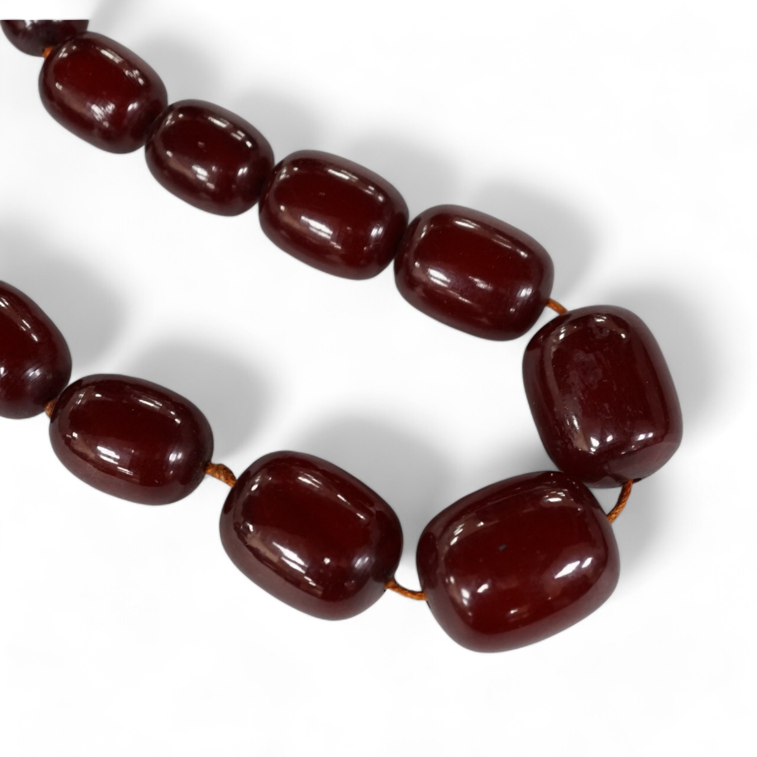 A single strand graduated simulated cherry amber necklace, 68cm gross weight 108 grams, Condition - fair